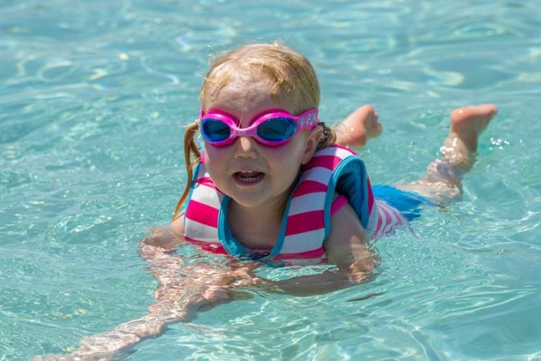 Girl Learning to Swim using a Swim Jacket and Little Twist Goggles