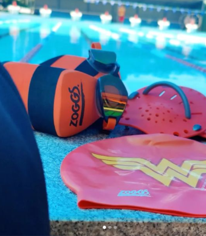 swim kit with hand paddles, pull buoy by the pool