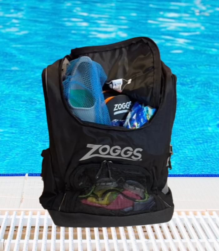 Man walking with swimmers backpack, goglges and jammers