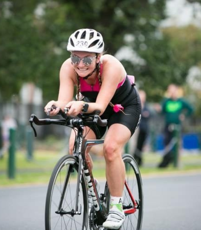 Alana Park riding a bike in a triathlon